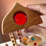 Detailaufnahme von einem Bauspiel Märchnfenster Holzbaustein mit einem roten Acryl-Funkelstein in der Mitte.