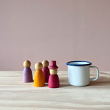 6cm großer Emaille Tasse für Kinder mit Henkel neben Spielfiguren aus Holz von Grapat.