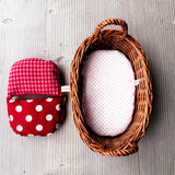 Links die Puppenbettwäsche für das Wichtelnest, rechts das Wichtelnest Puppenbett mit rosa getupfter Matratze.