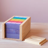 Die sechzig bunten Holzbausteine von Glückskäfer in ihrer Holzbox sortiert. Der Deckel ist offen und liegt daneben.