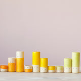 Die gelben, orangen und hellgrünen Lolas von Grapat in drei verschiedenen Größen farblich sortiert in einer Reihe.